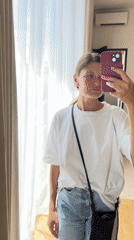 Woman takes mirror selfie in Mengwi hotel room