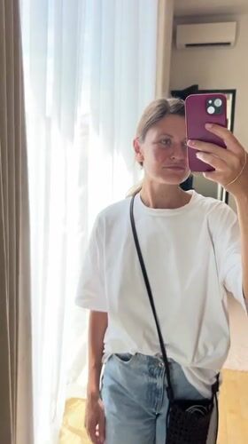 Woman takes mirror selfie in Mengwi hotel room