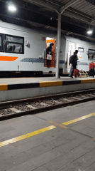 Passenger activity at Jatibarang station as a KAI train stops