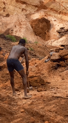 Worker hammers ground at Nigerian quarry site
