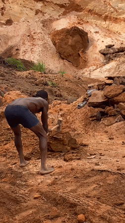 Worker hammers ground at Nigerian quarry site