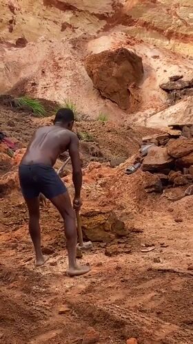 Worker hammers ground at Nigerian quarry site