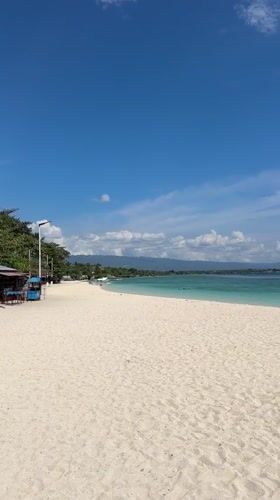 Quiet beach day on Saavedra's white sand shore