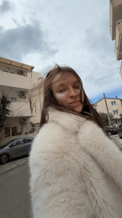 Woman in white fur coat photographed throughout Budva with dog