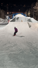 Snowboarder attempts night jumps at Krasnoyarsk terrain park