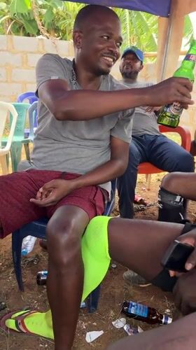 Men gather for casual afternoon drinks in Kurunduma, Nigeria