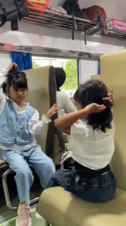 Train passengers share casual moments during late-night journey in Indonesia