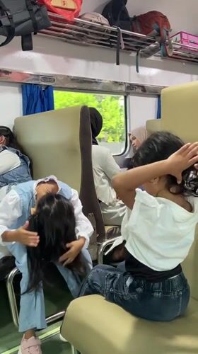 Train passengers share casual moments during late-night journey in Indonesia