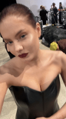 Woman in dark attire captured backstage in Riga
