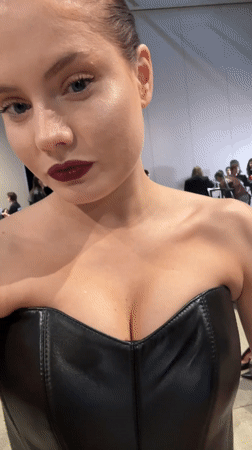 Woman in dark attire captured backstage in Riga