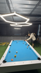 Man plays pool game at indoor venue in Thailand