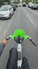 Rider uses Lime e-scooter on London residential street