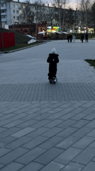 Child rides scooter at dusk in Chaikovsky, Russia