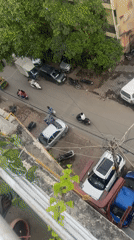 Aerial views capture crowded Delhi street scene with vehicles