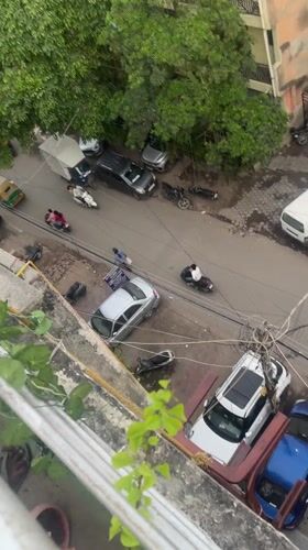 Aerial views capture crowded Delhi street scene with vehicles