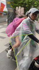 Motorcyclists in rain gear travel Đồng Nai roads
