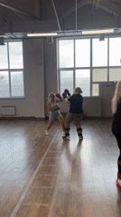Martial arts sparring session in a bright, open training space
