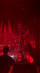 Costumed dancers perform under red lights at MU:IN BALI