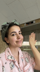 Woman in pajamas waves from tenth floor elevator in Daegu