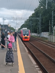 Train arrives at Saint Petersburg platform as passengers wait