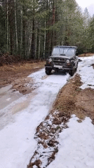SUV navigates muddy spring terrain in Russian woods
