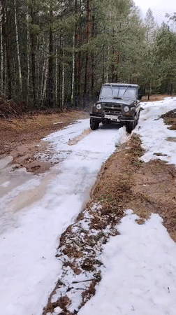 SUV navigates muddy spring terrain in Russian woods