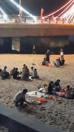 Beach gatherings and statue interactions documented in Nha Trang