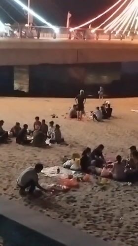 Beach gatherings and statue interactions documented in Nha Trang