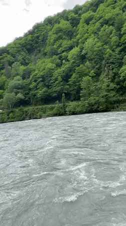 Person observed on bridge over turbulent river in Bzypta