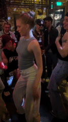 Woman with red hair dances at Moscow party