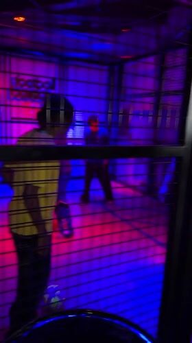 Neon-lit cage structure with occupants observed in Los Angeles