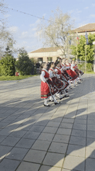 Young dancers perform Bulgarian folk dance in traditional costumes
