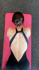 Woman performs morning foam rolling routine at Tyumen gym
