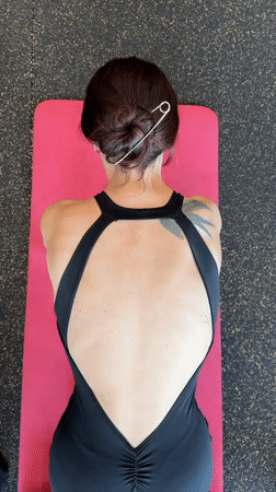 Woman performs morning foam rolling routine at Tyumen gym