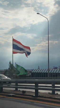 Thai flag flying from a bridge flagpole in Bangkok
