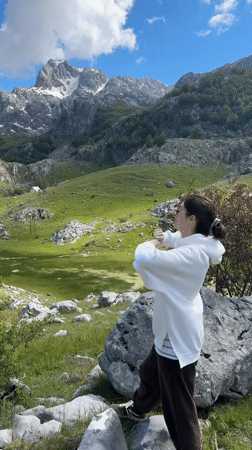 Woman celebrates scenic mountain views in Brskut, Montenegro