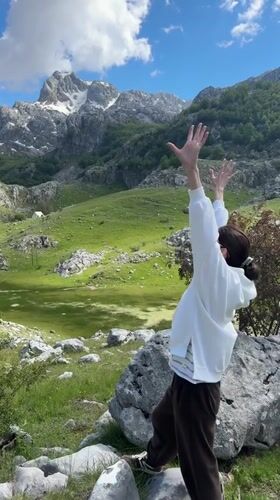 Woman celebrates scenic mountain views in Brskut, Montenegro