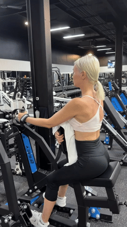 Woman exercises at neon-lit gym in Choeng Mon, Thailand