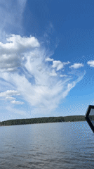 Child enjoys boat ride with binoculars on Russian lake