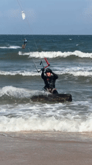 Kite surfers and beachgoers on a Mũi Né morning
