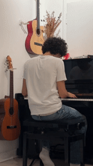 Young pianist performs in Pétange with child observer nearby