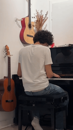 Young pianist performs in Pétange with child observer nearby
