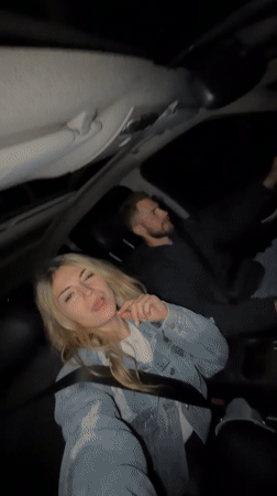 Couple enjoys music while driving through Montenegro at night