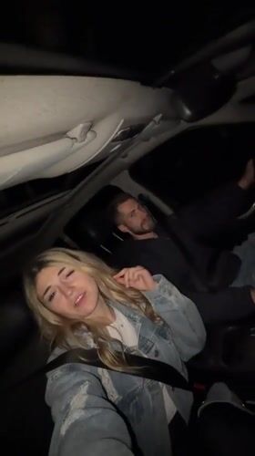 Couple enjoys music while driving through Montenegro at night