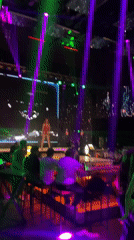 Woman performs on stage at Plovdiv nightclub with lights, screens