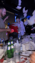 Men throw white papers in dimly lit Sofia venue