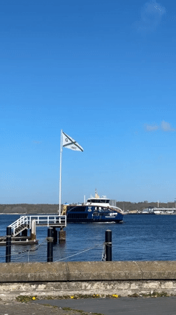 Woman documents sunny spring day touring Kiel marina and city