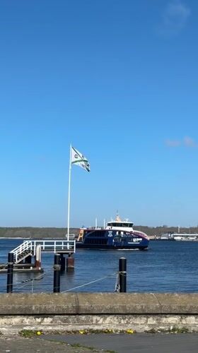 Woman documents sunny spring day touring Kiel marina and city