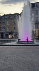 Plovdiv's pedestrian zone at dusk: fountains, koi ponds, purple lights