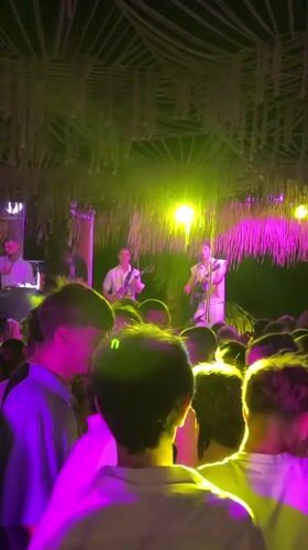 Late-night outdoor party scene in Burgas, live band and dancers